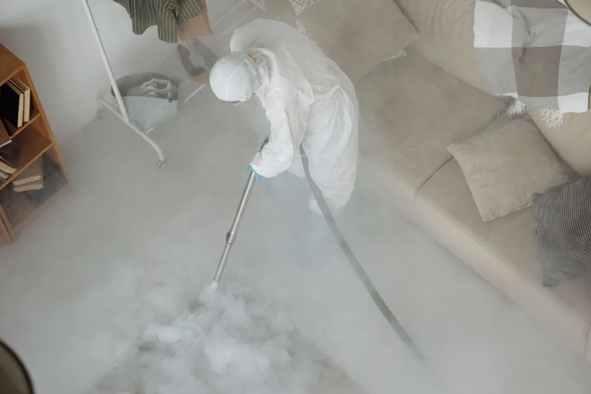 Biohazard cleanup technician in protective equipment, Old West Austin, Austin, TX
